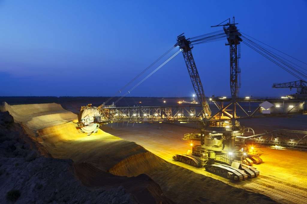A lignite pit mine with a big bucket-wheel excavator, one of the worlds largest moving land vehicles with night blue sky.
